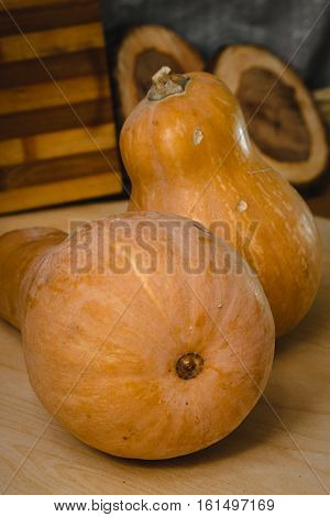 Two pumpkins on wooden table. front view