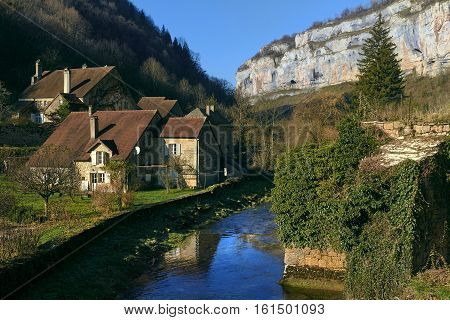 Small river runs through the centre of the Baume-les-Messieurs village. Jura department of Franche-Comte. Baume-les-Messieurs is classified as one of the most beautiful villages of France