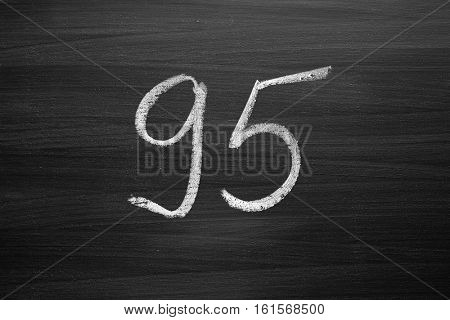number ninety five enumeration written with a chalk on the blackboard