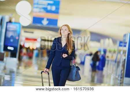 Business Woman With Hand Luggage In International Airport