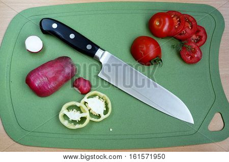 Knife cook universal with a blade like Santoku on a chopping board