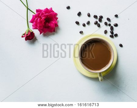 Coffee time with beauty pink flower on white desk of relaxation in morning break time holiday or weeknd Top view and copy space