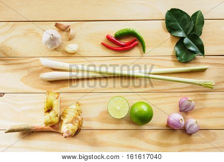 Top view of fresh ingredients various vegetable for cooking thai food (tom yam) on wooden table Health and herb food background