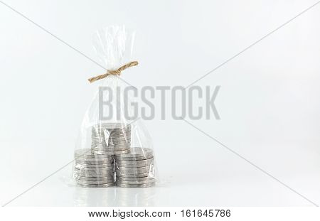Financial saving and coins background concept - Close up stack of coins in plastic bags of coins on white background and copy space