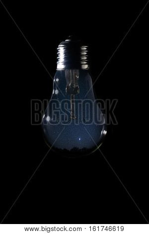 Beautiful Night Sky Inside Of Light Bulb On Dark Background.
