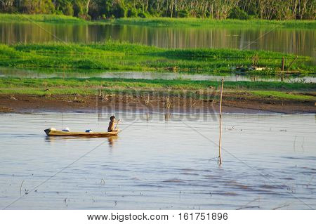 Fisherman On A Canoe