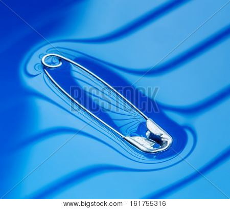 Physical experiment - pin floating on water surface.