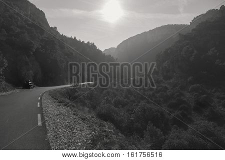 Empty winding mountain road in Provence. Provence-Alpes-Cote d'Azur France. Black and white image