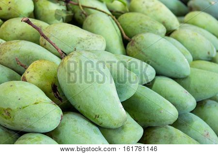 reen mangoes in the fresh market  background