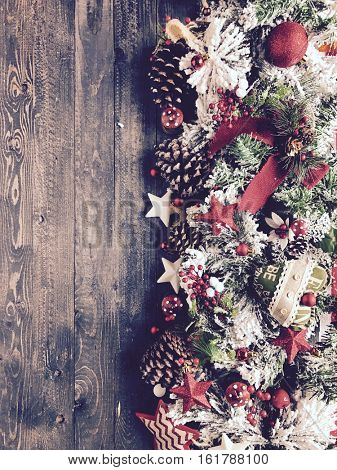Close up of Christmas tree decorations like stars, tree leaves, oranges and bables. Ideal to use for seasonal backgrounds