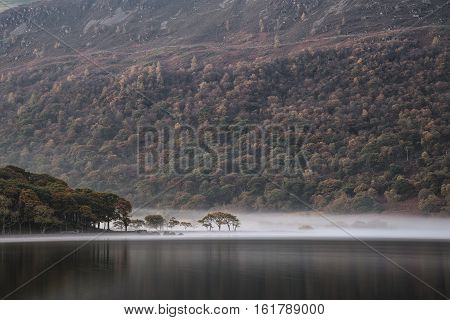 Beautiful Autumn Fall Landscape Image Of Crummock Water At Sunrise In Lake District England