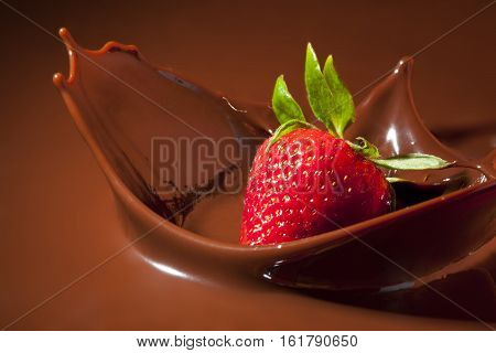 Fresh Ripe Strawberry Splashing in Milk Chocolate