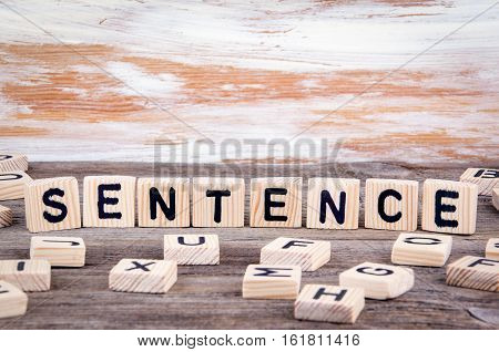 Sentence from wooden letters on wooden background.