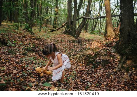 girl standing in the woods portrait of a girl in the woods.bear