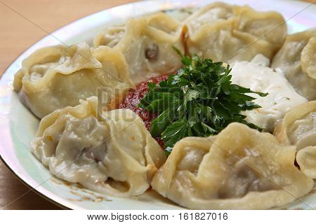 Manta on a plate with two kinds of sauce.