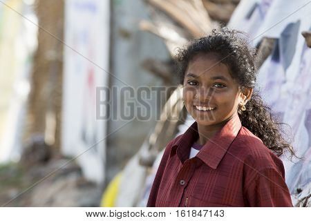 Illustrative image. Pondicherry Tamil Nadu India - Marsh 07 2014. Poor child with smile feeling in the street