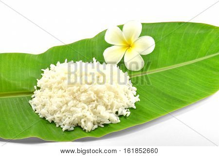 Rice and white flower on the leaf of banana tree isolate