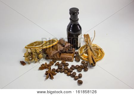 composition of chocolate, coffee, cinnamon and dried orange on a white background