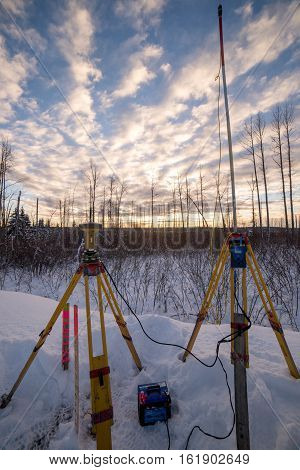 Survey equipment set up in snow at sunset canada