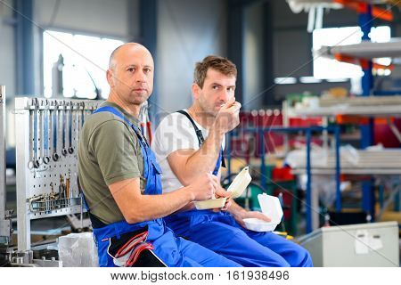 Two Worker In Factory Have A Break