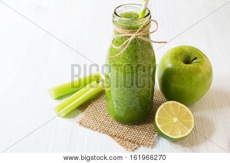Healthy celery smoothie with green apple and lime in bottle. Green smoothie for weight loss and detox selective focus horizontal