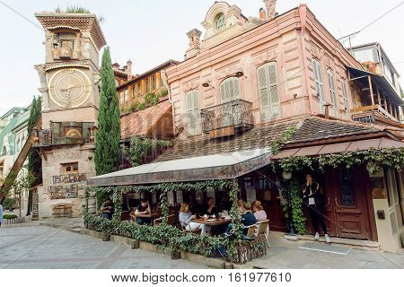TBILISI, GEORGIA - SEP 25, 2016: People sitting at restaurant inside famous Rezo Gabriadze Marionette Theater on September 25, 2016. Tbilisi has population of 1.5 million people