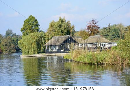 Luxury bungalows on Norfolk Broads with river in foreground