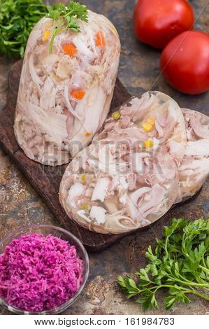 Aspic with meat and horseradish on a old table