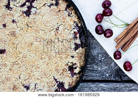 Homemade Cherry crumble and cherries on an old wooden table background.Selective focus.