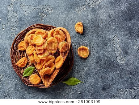 Dried Apricots On Gray Concrete Background With Copy Space. Top View.