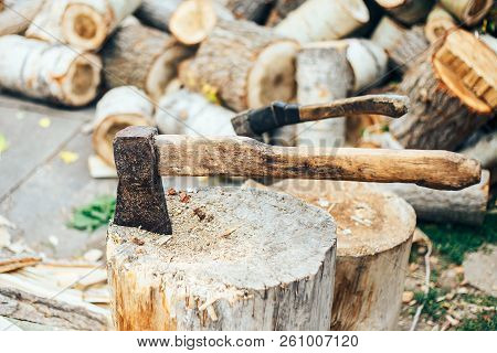 A Sharp Blade Of An Ax That Sticks Out In A Wooden Chock. Rustic Concept