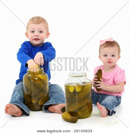 Liebenswert Geschwister, jungen und Mädchen, Essen aus riesigen Gurke Gläser over white Background.