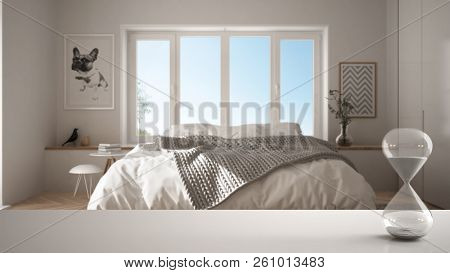 White Table Or Shelf With Crystal Hourglass Measuring The Passing Time Over Modern Bedroom With Pano