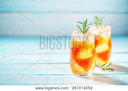 Gin Cocktail With Rosemary And Grapefruit On A Turquoise Background, Selective Focus.