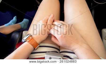 Closeup Photo Of Young Woman Scared Of Flying In Planes Sitting In Passenger Seat And Rubbing Hands