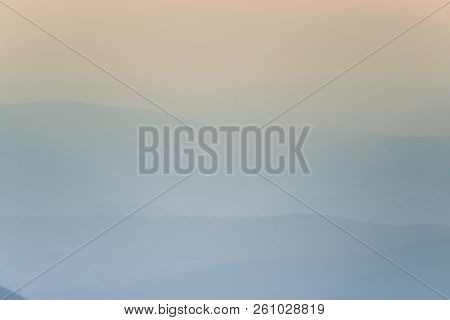 A Dreamy, Hazy Landscape Of A Mountains Close To Sunset. Sun Flase And Misty Look In Blue Tones. Mo