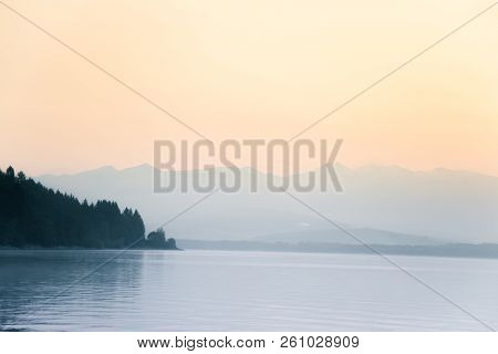 A Dreamy, Hazy Landscape Of A Mountains Close To Sunset. Sun Flase And Misty Look In Blue Tones. Mo