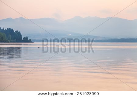 A Dreamy, Hazy Landscape Of A Mountains Close To Sunset. Sun Flase And Misty Look In Blue Tones. Mo