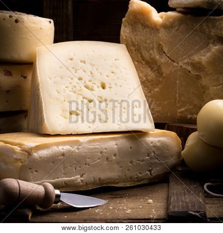 Parmesan, Taleggio, Caciotta And Asolo Cheese On Dark Wooden Table