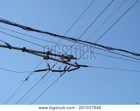Wires Pole With Blue Sky. Electrical Wires On A Background. Electric Cables. Power Cable With Blue S