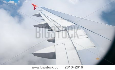 Image Of Airplane Wing Flying Above Cloads And Blue Sky