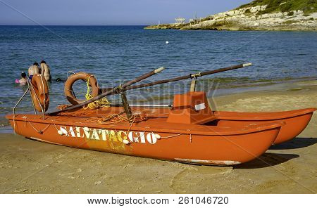 Lifeboat On The Beach. The Sea Is Calm And The Bathers Are At Sea.
In Italian, The Word 