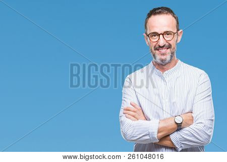 Middle age hoary senior man wearing glasses over isolated background happy face smiling with crossed arms looking at the camera. Positive person.