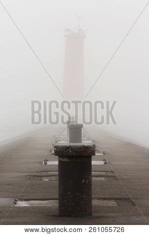 A Pier On Lake Michigan With A Lighthouse Obscured By Thick Fog.  Sheboygan, Wisconsin, Usa.