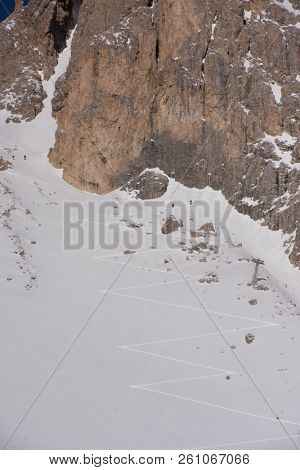 hiking touring ski tracks in snow climbing to mountain top at beautiful winter day with fresh snow