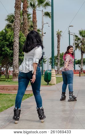Two Chubby Girls With Inline Skates In The Park