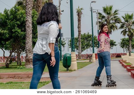 Two Chubby Girls With Inline Skates In The Park
