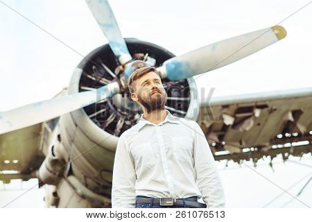 The Man In The Shirt Stands At The Old Plane