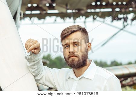 The Man In The Shirt Stands At The Old Plane