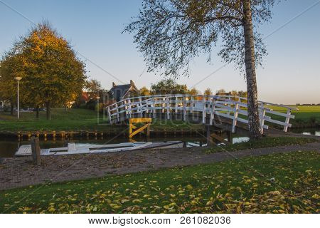 View Of The Authentic  Village, With Canal, Wooden Small Footbridge And Birch, Holland, Friesland Pr